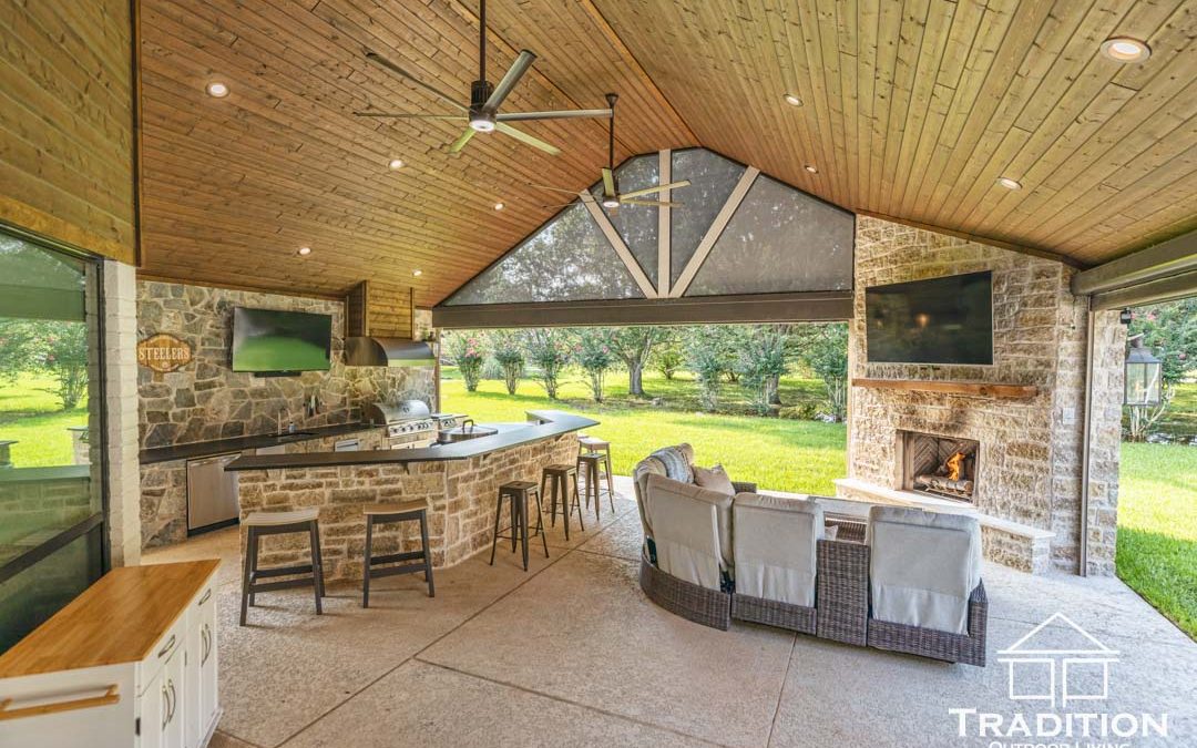 Custom Outdoor Living Space in Fulshear, TX with Motorized Screens, Outdoor Kitchen & Stone Fireplace